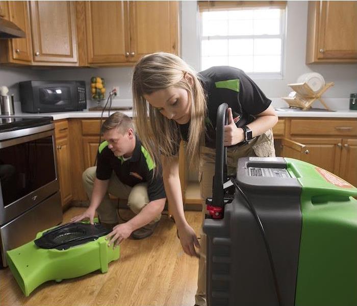 < img src =”cleaning.jpg” alt = "a SERVPRO crew setting up machines to clean a kitchen " >
