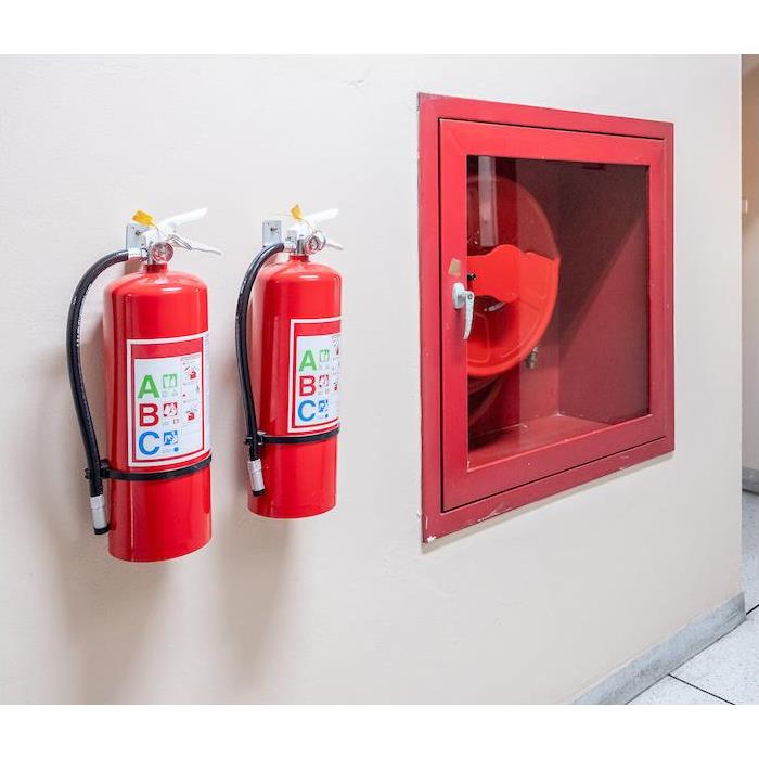 img src ="extinguisher" alt = "two fire extinguisher hanging on a tan interior wall  " >