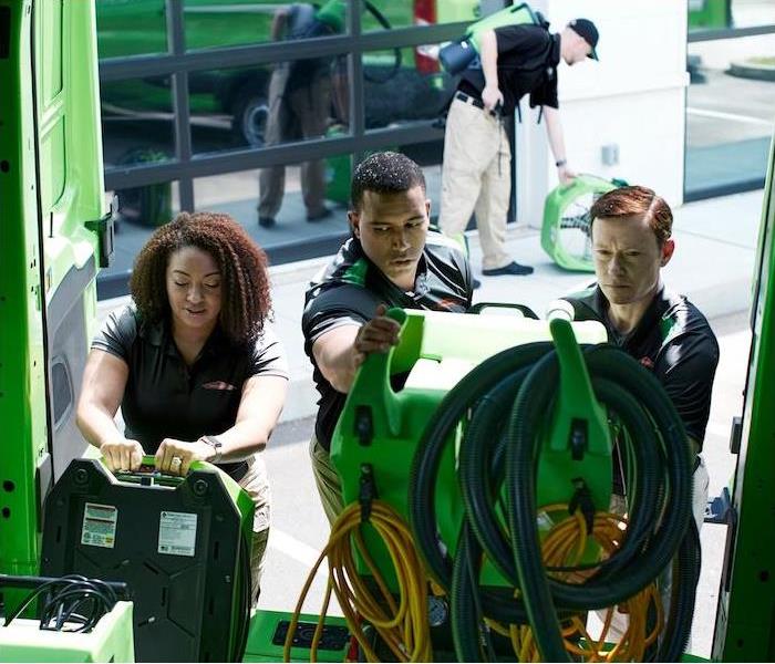 SERVPRO employees loading truck with work equipment